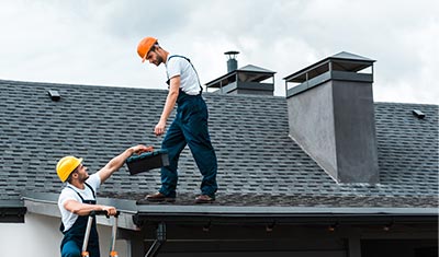 picture of two workers repairing a roof
