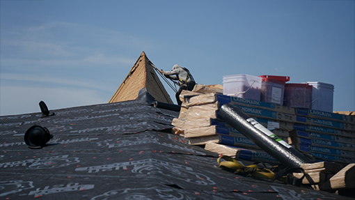 two roofers talking with each other and going over material
