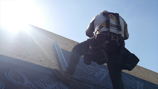 two roofers talking with each other and going over material